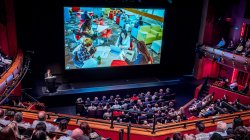 Photo of Dr. Cole speaking before a packed house at Kasser Theater