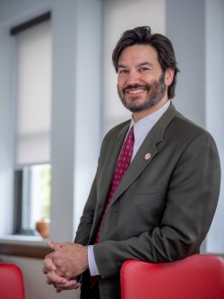 Montclair State University President Jonathan Koppell poses inside a building on campus.