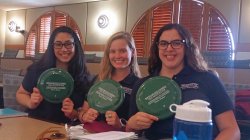 students holding PSEG branded frisbees