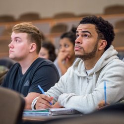 Image of a student sitting in a lecture class.