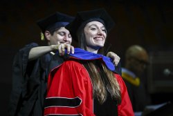 photo of doctoral student Bartlett being hooded at Commencement Ceremony