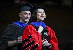 photo of doctoral student Hayden Valdespino being hooded at Commencement Ceremony