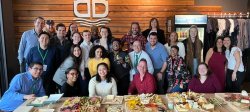 photo of students and staff posing at reception