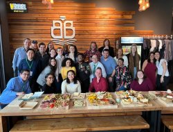 photo of students and staff posing at reception