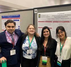 photo of students standing together in front of poster presentation