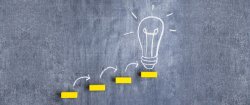 Image of black board with a light bulb drawn on it