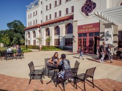 Students sitting outside the Feliciano School of Business enjoying a nice sunny day.