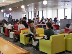 Students sitting on the third floor of the Student Center studying and having conversations.