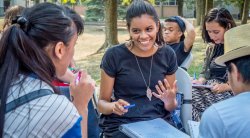 Image of a student talking with peers in an outdoor class.