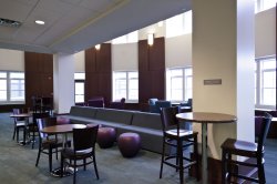 The lounge in Machuga Heights featuring some high-top tables and couches.
