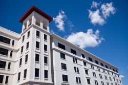 The outside of Dinallo Heights on a bright, sunny day.