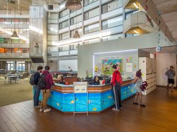 The front desk at Blanton Hall with some students milling about.