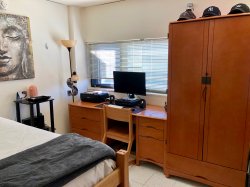 A desk and bed in a Single Room in Blanton Hall.