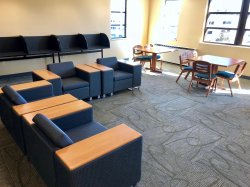 Another common area in Sinatra Hall featuring some chairs and some tables.