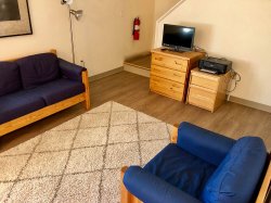 The living room area of a multi-floor Hawk Crossings unit.
