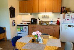 The kitchen area of a multi-floor Hawk Crossings unit.