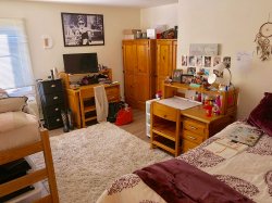 A bedroom in a multi-floor Hawk Crossings apartment.