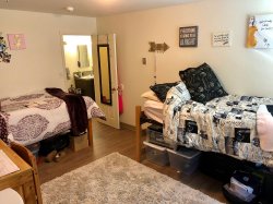 A bedroom in a multi-floor Hawk Crossings apartment.