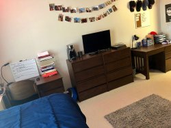 A bed, TV and two desks in a Double Room in the Heights