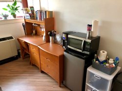 A Single Room in Stone Hall with a desk, microwave and mini fridge.