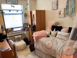 The bedroom with bed and closet in a Single Apartment in the Village Apartments.