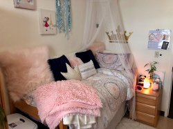 The bed in one of the bedrooms in a Single Apartment in the Village Apartments.