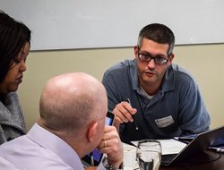 PACE project group having discussion at table.