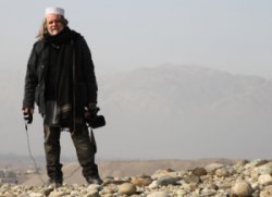 Photo of cameraman standing on rocks