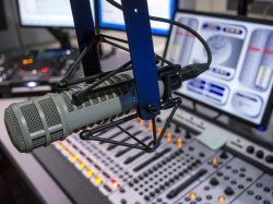 Photo of microphone in front of mixing board