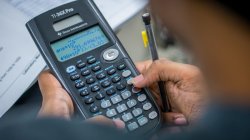over-the-shoulder view of student using scientific calculator