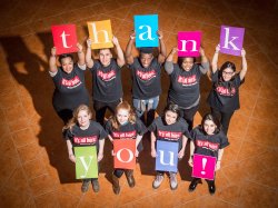 photo from abve of students holding signs with letters spelling out thank you