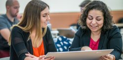 two students looking at posterboard together