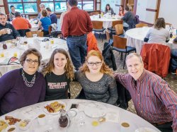 A family posing at the Homecoming Family Breakfast.