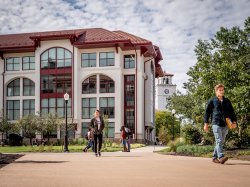 Students walking around campus on a cloudy day.