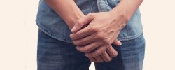 White, male holding his hands, crossed over his pants