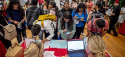Image of a student shaking hands with a prospective employer at a campus career fair.