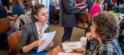 Picture of a student speaking with a prospective employer at a career fair.