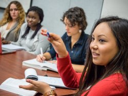 Photo of honors students taking notes in classroom.