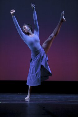 Photo of dancer performing high kick.