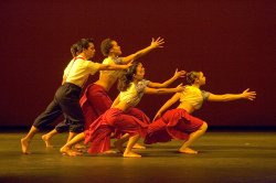 Photo of five dancers leaning dramaticall toward something out of frame.