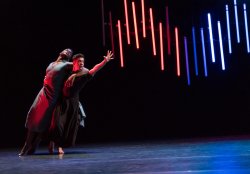 Two male dancers reaching dramatically for something invisible yet just out of reach