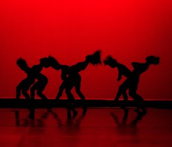 dancing silhouettes in front of piercing red background
