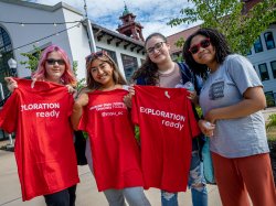 Four Summer Bridge students pose with red t-shirts outside of Cole Hall at UC's College Prep Cookout.