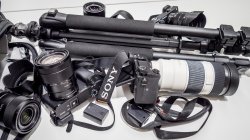 Photography equipment, including cameras, lenses and a tripod.