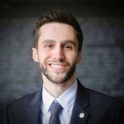Architectural Design Specialist Mike Chiappa smiles in a suit for a professional headshot