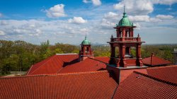 View of the top of a Montclair State University building with tree tops in background