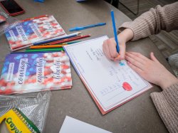 Students writing cards on a service day.