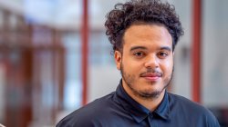 Ashon Lanada on stairs in school of business