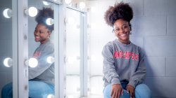 Ciara Allen in green room in front of vanity mirror